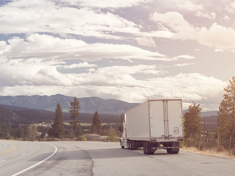 Panorama of beautiful nature and a mountain highway with a semi